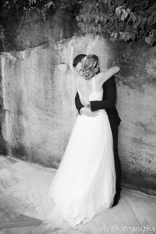 Couple hugging showing the brides back - wedding photography sydney